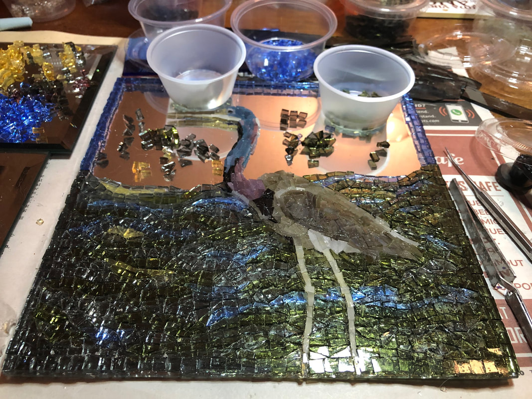 A picture of my heron mosaic, 2/3 complete, with loose glass tesserae.